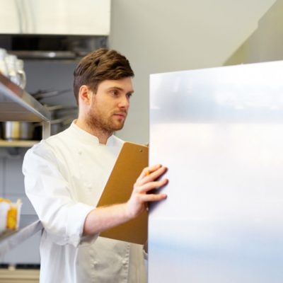 Chef checking on commercial refrigerator